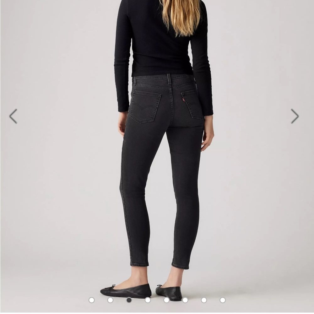 Levi's 721 black high rise skinny jeans with rips in knees